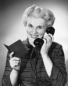 Using Phone Prints: Woman using phone, holding small book in one hand