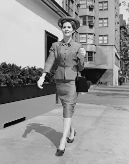 Woman walking down sidewalk