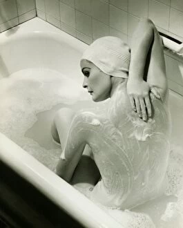 Back Gallery: Woman washing herself in bathtub, (B&W), elevated view
