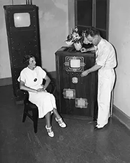 Legs Crossed Prints: Woman Watches Inventor Demonstrate TV