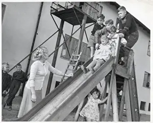 Slide Prints: Woman Watching Children Play On Slide