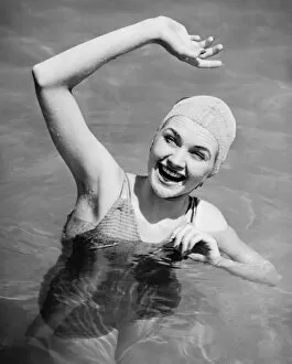 Tourist Resort Gallery: Woman waving in pool (B&W), , elevated view