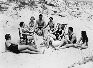 Swimming Gallery: Woman wearing bathing suit, sitting by wall
