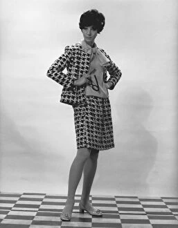 1960s Fashion Gallery: Woman wearing costume posing in studio, (B&W), portrait
