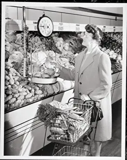 Groceries Prints: Woman Weighing Potatoes in Grocery Store