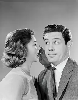 Girlfriend Prints: Woman whispering into man's ear, man pulling funny face