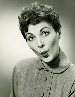 35 39 Years Collection: Woman whistling in studio, (B&W), portrait