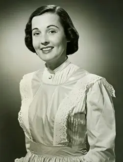 1950s Style Prints: Woman in white apron posing in studio, (B&W), (Portrait)