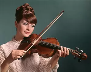 Woman in white dress playing violin