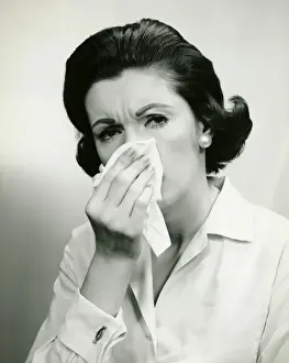 Medical Condition Prints: Woman wiping nose with handkerchief, (B&W), (Portrait)