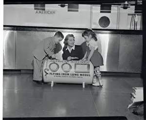 Poliomyelitis Prints: Woman and Youngsters Posing with Iron Lung Replica