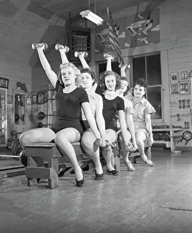Women On Bench Exercising With Barbells