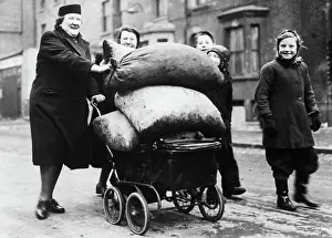 Crisis Prints: Women and Children Pushing Bags of Coal