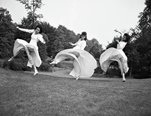 Graceful Prints: Women Dancing in Meadow