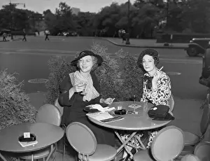 Two Women Drinking At Sidewalk Cafe