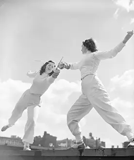 Fencing Prints: Two Women Fencing on Rooftop