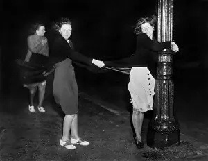 Hurricane Prints: Women Holding Lamp Post In Wind