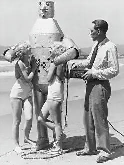 Strange Prints: Women and Inventor with Robot at Beach