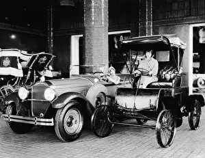 Prints of Two women sit in the driver's seats of adjoining cars in an automobile showroom, one an antique and the the other a new Packard Sedan, circa 1920. (Photo by Frederic Lewis/Getty Images) Urban Echoes of America’s Golden Age: Women In New, Old Packard Cars
