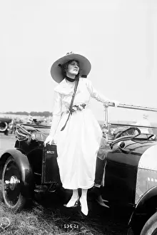 Women Posing Standing on Oldsmobile