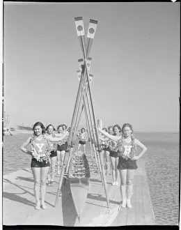 Women Rowers Holding up Oars
