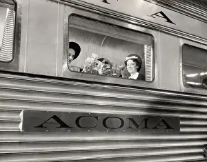 Two Women Seated on Train Looking Out Window