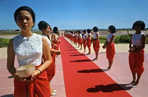Women Standing Next to a Red Carpet
