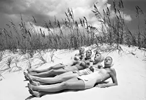 Women Sunbathing At The Beach