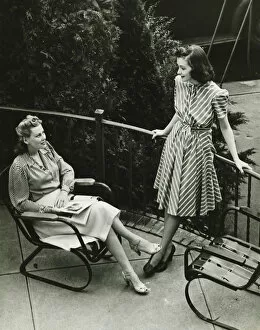 Railing Collection: Two women talking on balcony, (B&W), elevated view