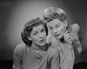 Worried Prints: Two women talking indoors