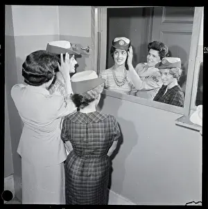 Recruit Prints: Women Try On Military Hats In Mirror
