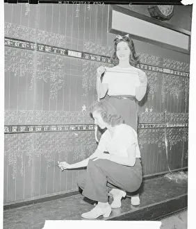Women Updating a Stock Board