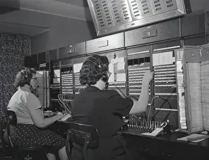 Mature Women Prints: Two women wearing headsets, working on telephone switchboard