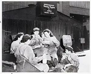 Women Welders Seated, Eating Lunch