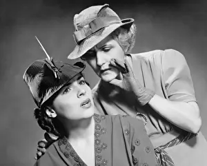 Glove Prints: Two women whispering in studio, (B&W), portrait