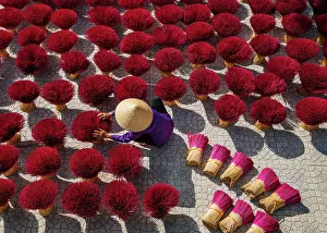 Light Prints: Women Worker with conial hat drying the Incense sticks on yard outdoor