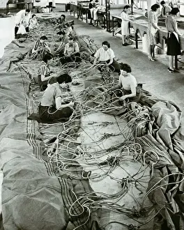 Tire Prints: Women Working Amongst Snake-Like Wires