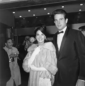 Prints of 1962: American actors Natalie Wood (1938-1981) and Warren Beatty smile as they attend the premiere of director David Lean's film, Lawrence of Arabia. Wood wears a fur coat and long, white gloves Grace, Glamour & Timeless Elegance: Wood & Beatty