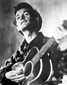 Woody Guthrie Portrait With Guitar