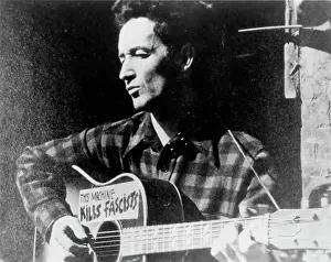 Woody Guthrie Portrait With Guitar