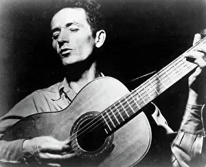 Woody Guthrie Portrait With Guitar
