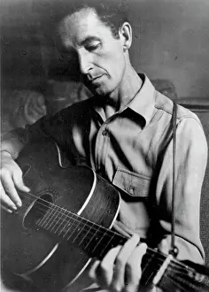 Woody Guthrie Portrait With Guitar