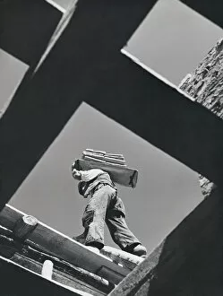 Worker carrying materials, seen from below