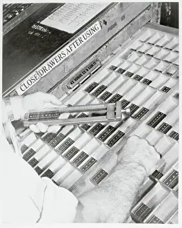 Worker Choosing Typeset Letters
