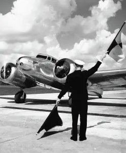 Airport Prints: Worker Flagging in Airplane