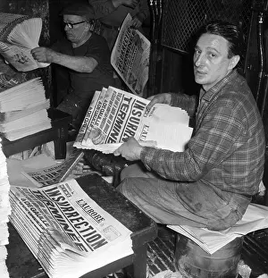 Worker Holding Newspaper Announcing Insurrection Terminated