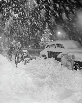 Snowfall Prints: Workers Clearing Park Avenue Sidewalk in a Blizzard