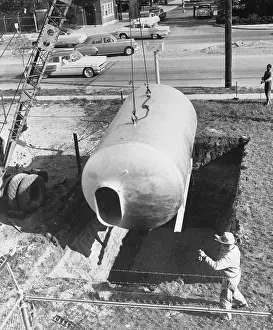 Shelter Prints: Workers Placing Tank into Ground
