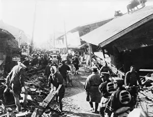 Workers, Police Work On Ruined Buildings