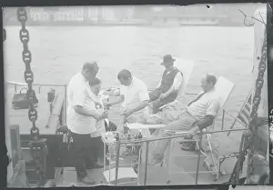 Caring Prints: Workers Receiving Foot Treatment on Boat